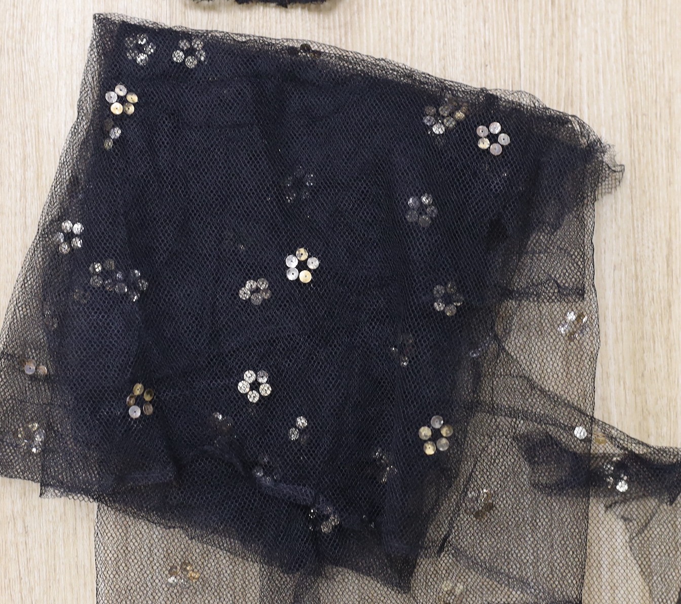 A suitcase of mixed 19th and 20th century black machine and bobbin laces, servants bonnets, cream lace, etc